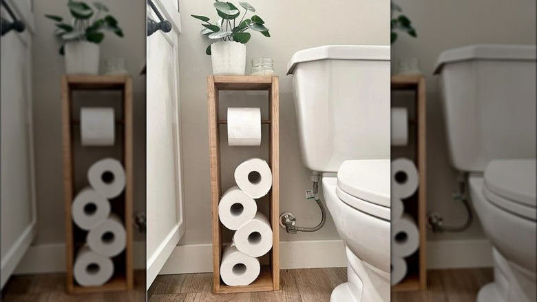Generic Sam's Club toilet paper tucked into wooden toilet paper storage by toilet