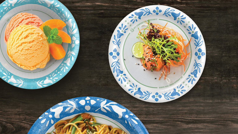 Dessert, entree, and appetizer stacked on Sam's Club paper plates with floral designs
