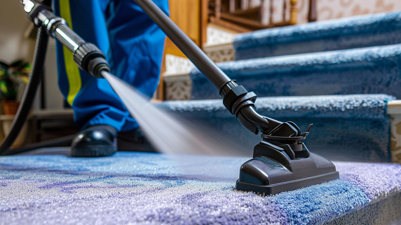 man using a carpet cleaning machine in the home