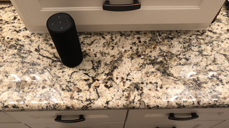 Portable speaker on bathroom counter