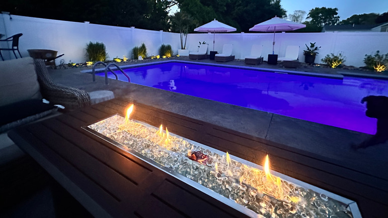 Linear fire pit at swimming pool
