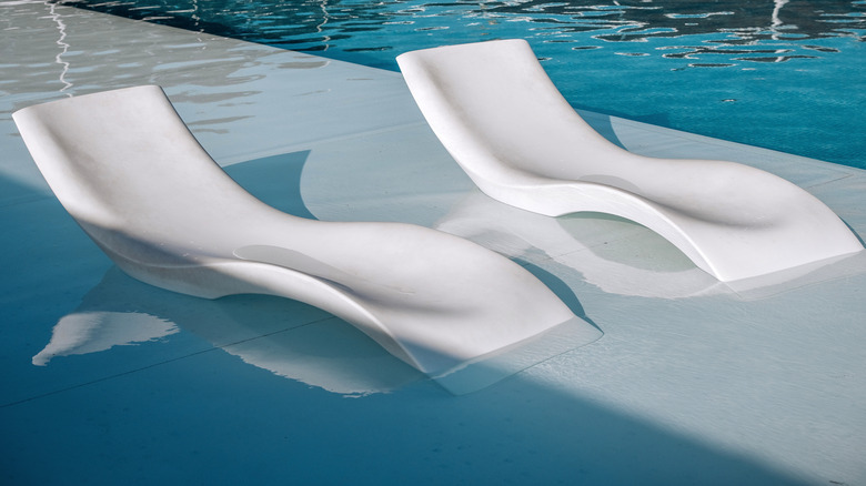 chairs on tanning shelf in pool