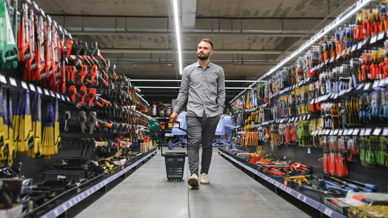 A man wandering the aisles of a hardware store