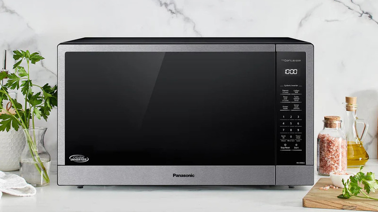 The Panasonic 2.2 cu.ft. Countertop Microwave sitting on a kitchen counter with cooking items nearby