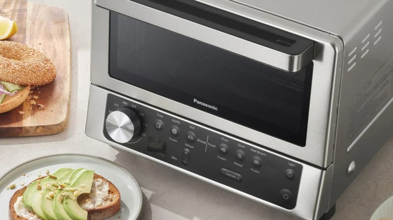 The Panasonic FlashXpress Countertop Toaster Oven with food on plates nearby