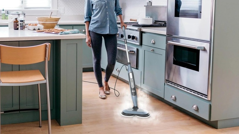 Woman using Steam and Scrub All-in-One Mop on kitchen floors