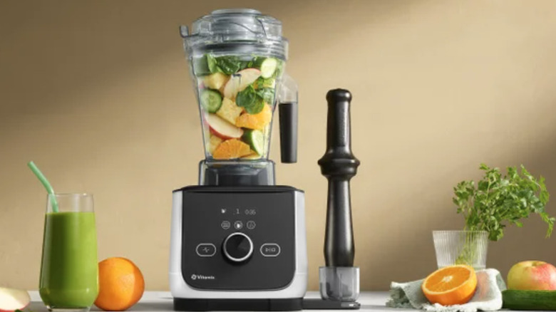 Vitamix Ascent X4 blender on a counter with fruits and herbs nearby