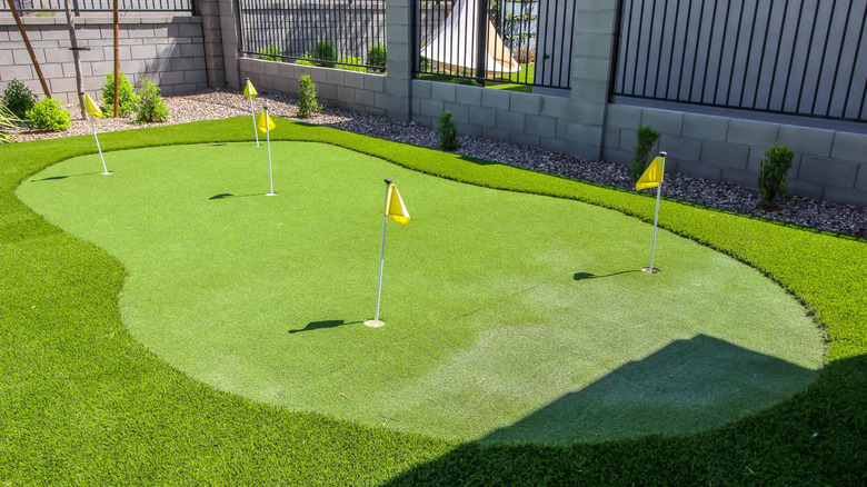 A five hole putting green area in a home's backyard
