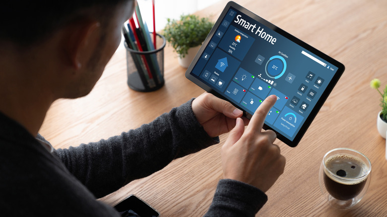 Man looking at smart home technology on a tablet