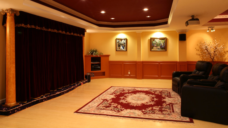 Old theatre style curtains drawn on a large screen in a basement