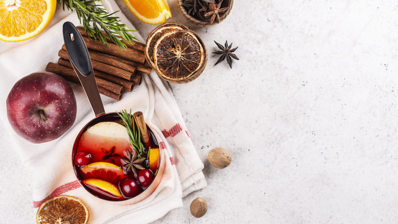 A simmer pot featuring apples, oranges, cranberries, rosemary, anise, nutmeg, and cinnamon