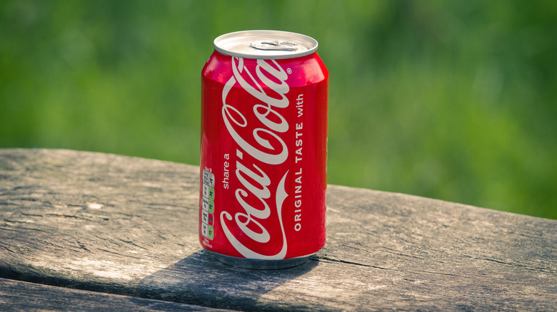 A Coca Cola red can on a table