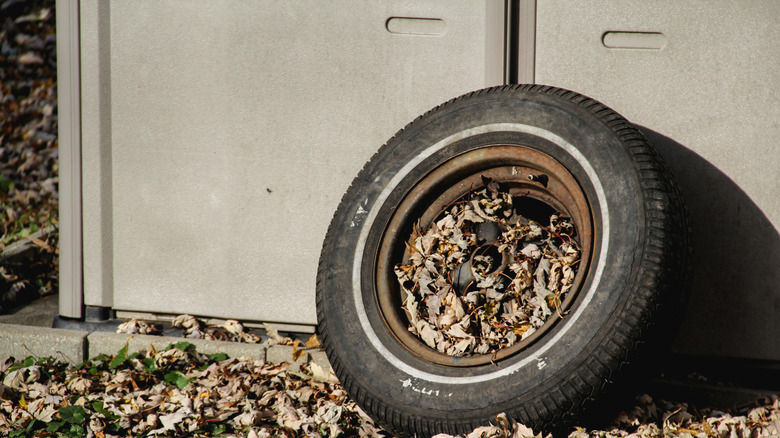 An old tire against a shed