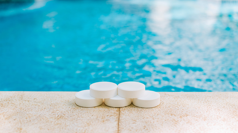 White chlorine tablets near a swimming pool