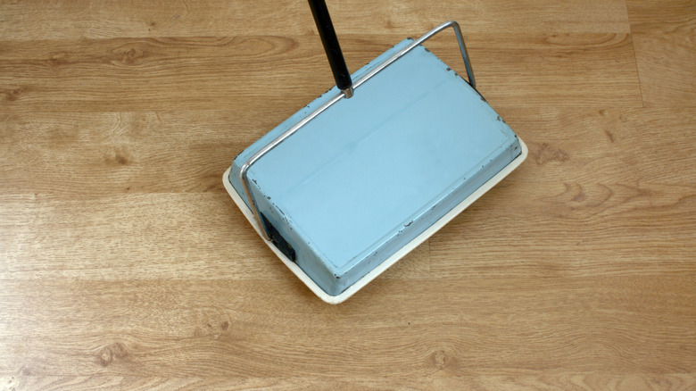 Antique carpet sweeper on a wooden floor