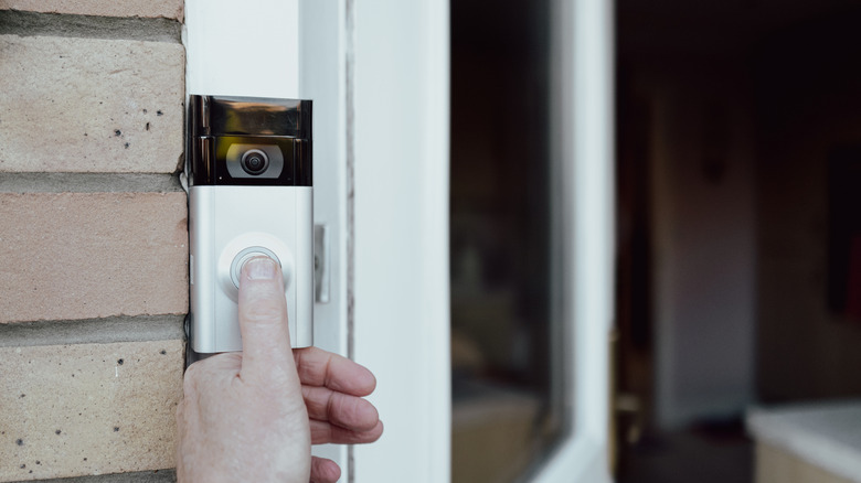 Doorbell with a security camera, by the side of a front door
