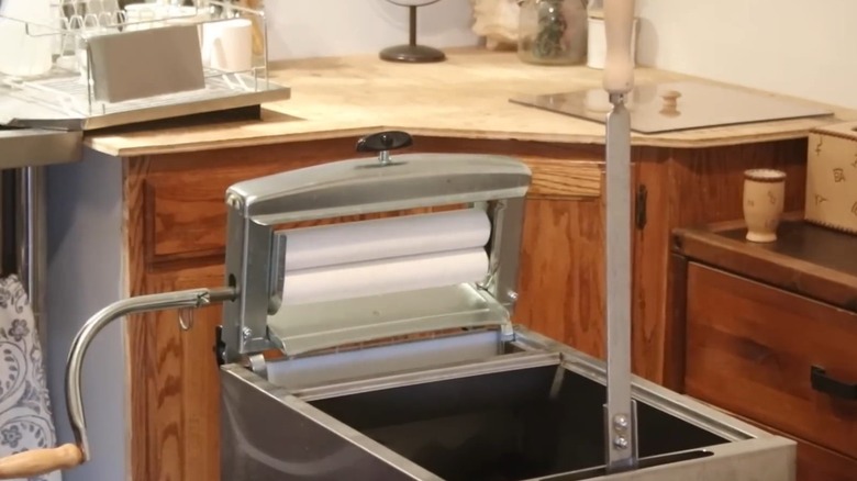 open hand crank washing machine in laundry room