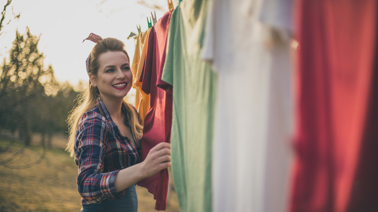 retro looking woman hanging out laundry