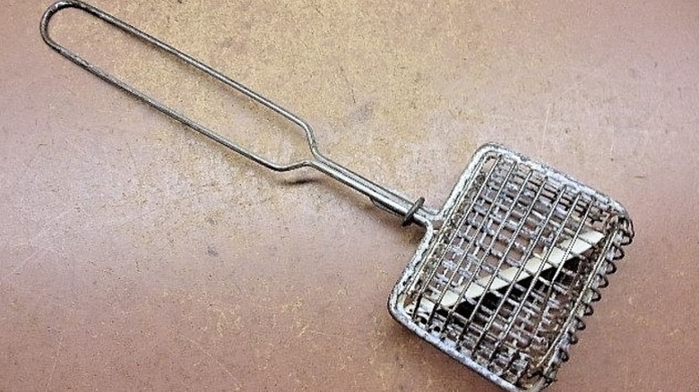 metal soap shaker with soap flake inside