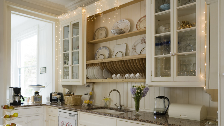 White farmhouse kitchen with glass cabinet doors