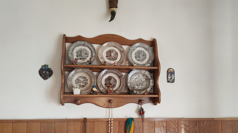 Vintage plate display rack mounted on wall