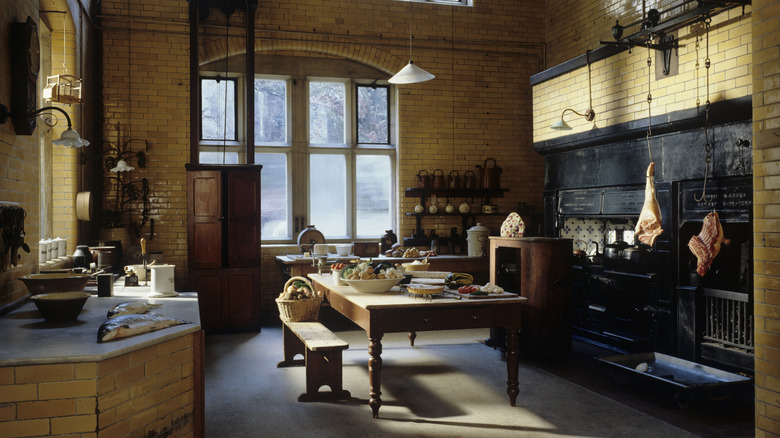 Rustic wood table island in large antique kitchen