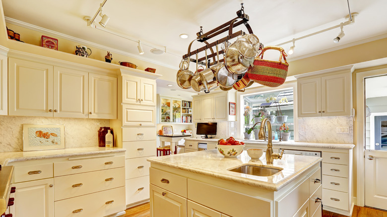 Ceiling-mounted pot rack in white modern farmhouse kitchen