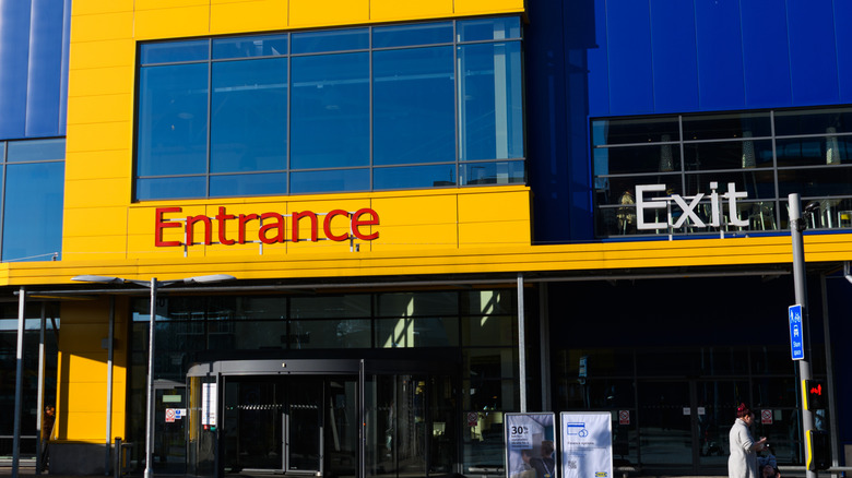 Exterior of an IKEA store with the entrance and exit marked with large signs