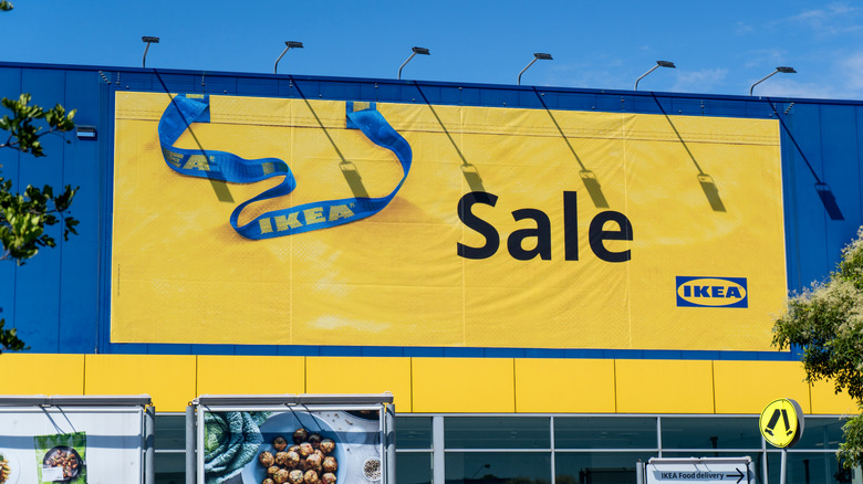 IKEA store exterior with a large yellow sale banner on it
