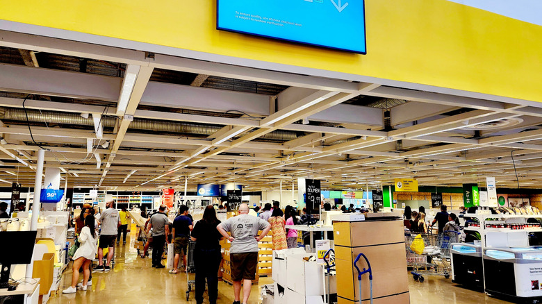Long lines of customers waiting for the checkouts at an IKEA store