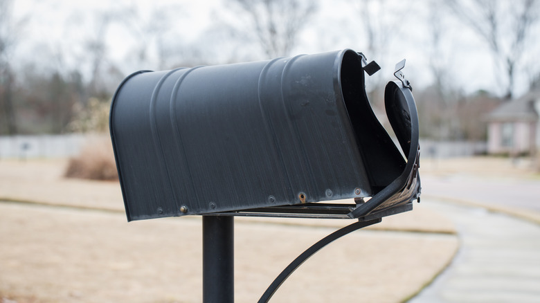 Mailbox that has been hit and partially crushed