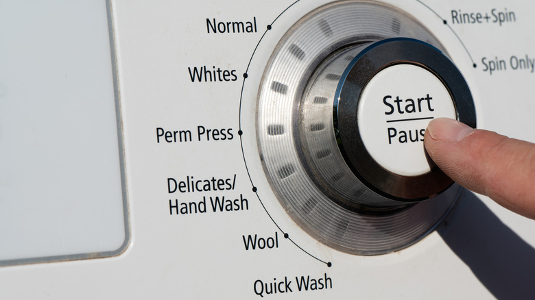 finger pausing washing machine