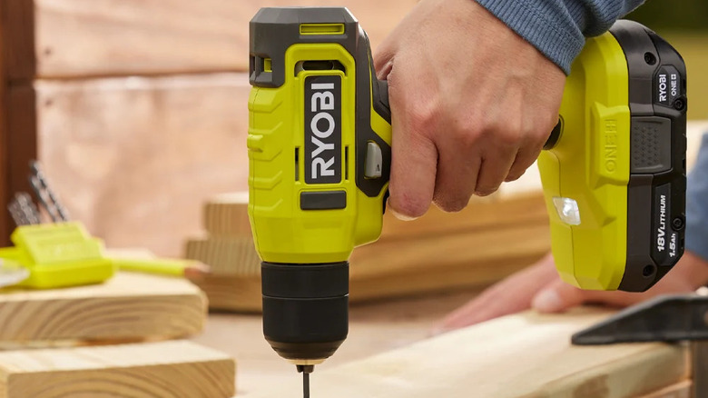 A person using Ryobi's 18V One+ Cordless ⅜-inch Drill/Driver