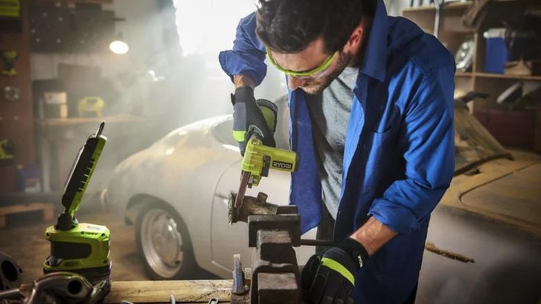 A person working with the help of Ryobi's 18V One+ Hybrid LED Project Light