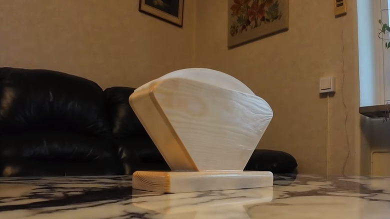Coffee filters in a home-made coffee filter holder on a marble table near a couch