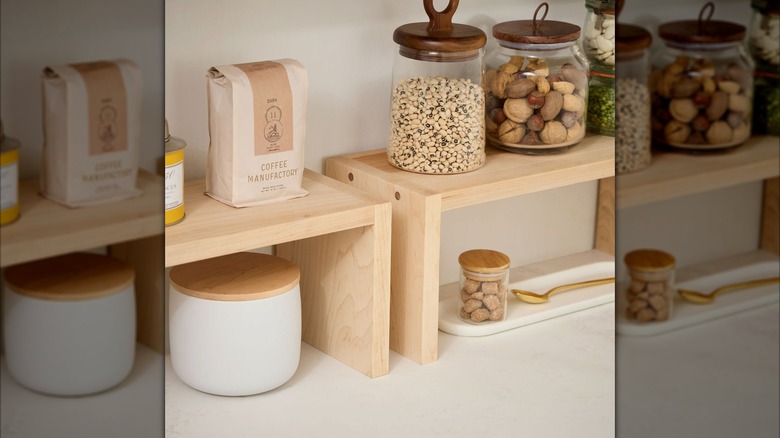 Glass jars and coffee on wooden risers on a kitchen counter