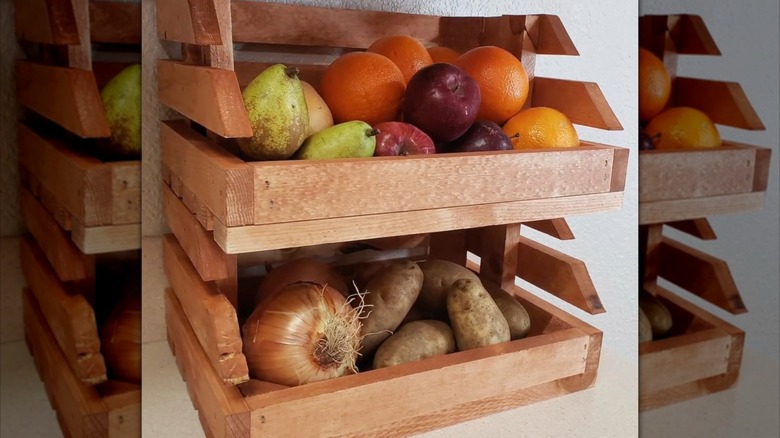 Fruits and vegetables in stacked crate trays on a counter