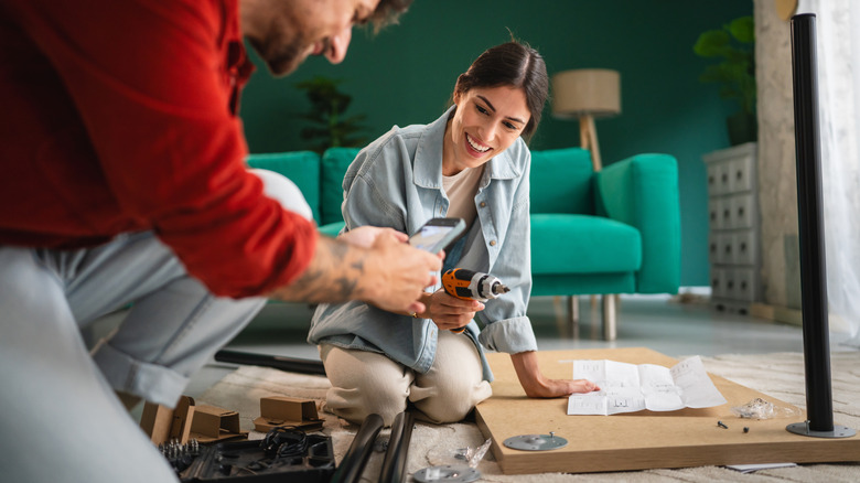 A couple assembling a table in their home