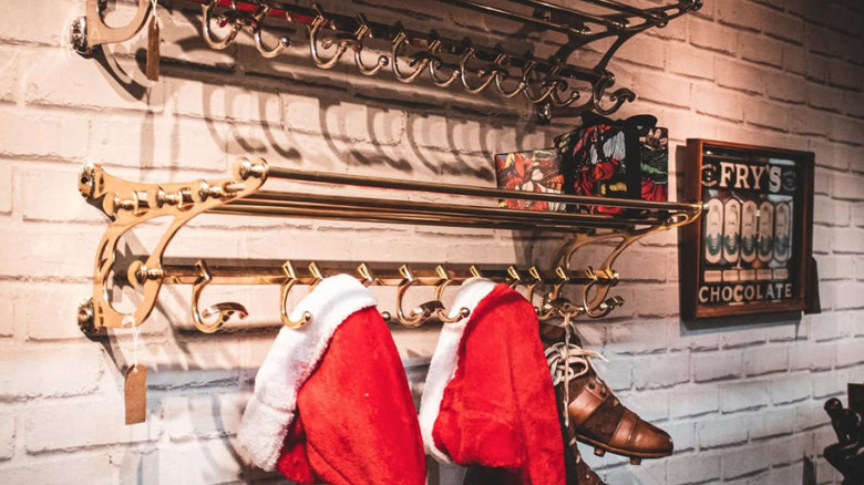 2 christmas hats hanging on train luggage rack
