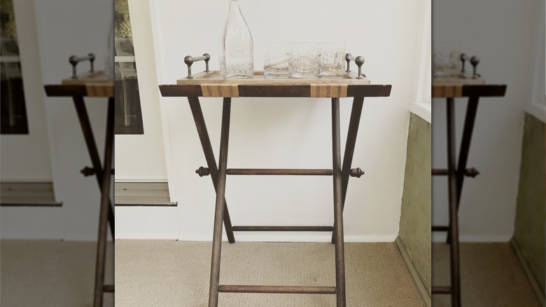 white tray with empty glasses and a punch bowl with fruit