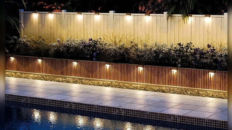 SOLPEX's Solar Deck Lights installed on wooden fencing