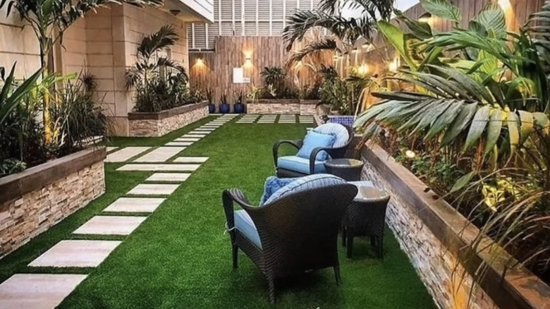 An outdoor seating area with wicker furniture and square pavers