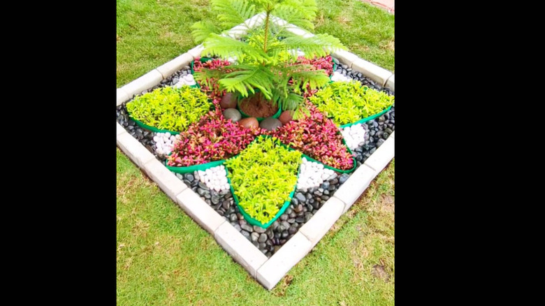 a square garden with a brick border and flower design