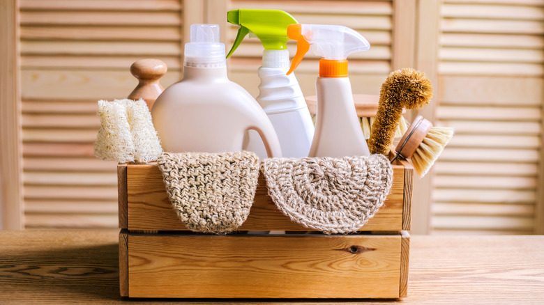 A set of cleaning supplies in a wooden box