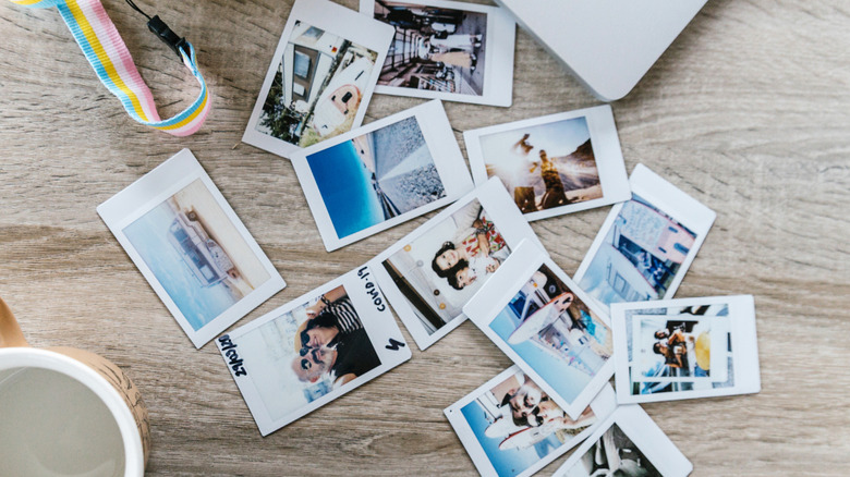 A collection of vacation polaroids scattered on a table