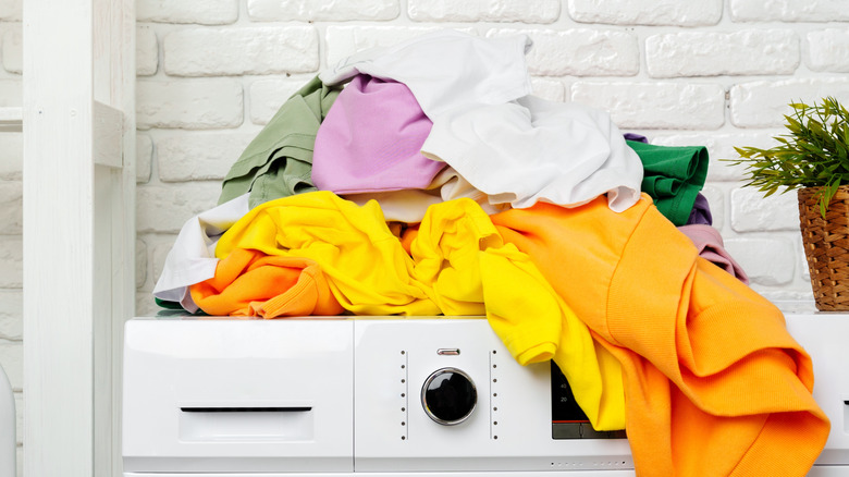 Laundry piled on top of the unit