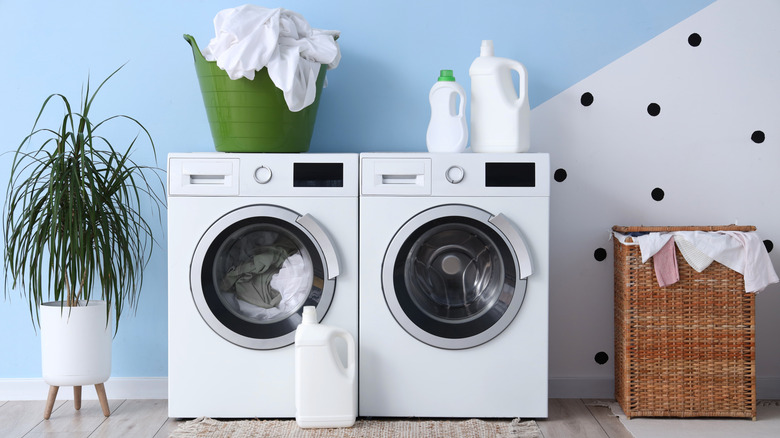 A basket and cleaning supplies placed on top of a washing machine