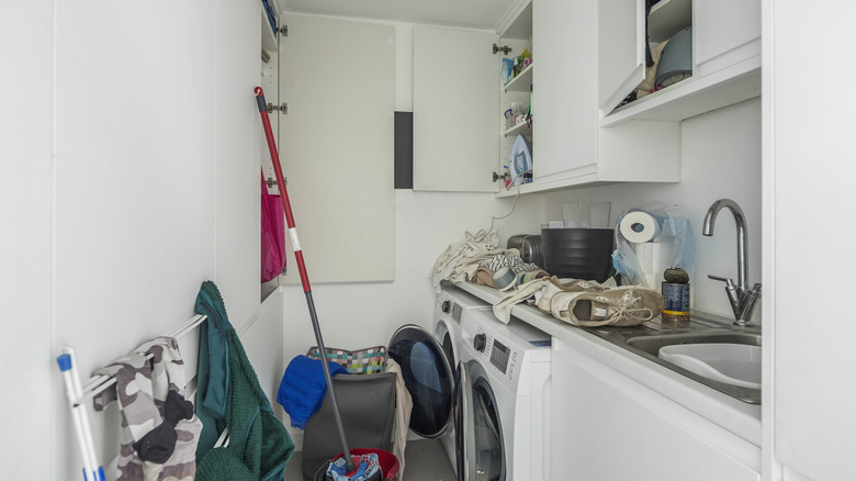 Messy, disorganized storage in a laundry room