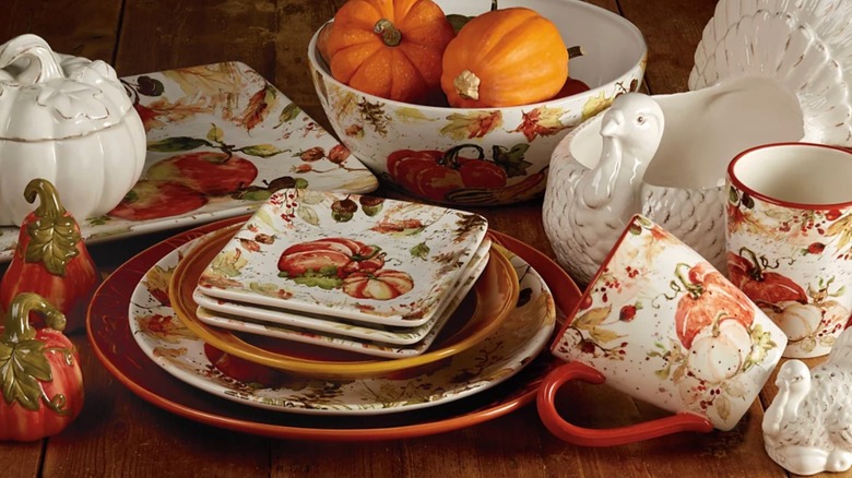 Plates with pumpkins, acorns, apples, and other fall elements decorated on them