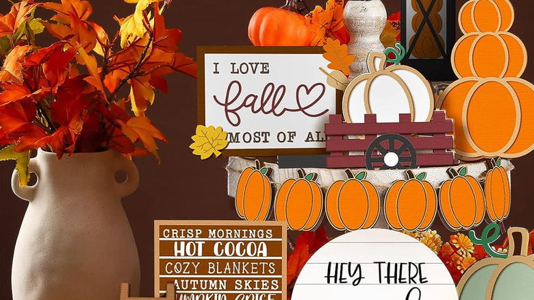 A picture filled with various Thanksgiving decorations including signs and pumpkin-themed decorations